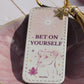 PU leather keychain with “Bet on Yourself” quote, gold star charm, and tassel, symbolizing courage and confidence by Belivra.