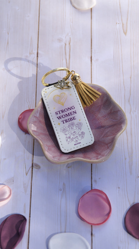 PU leather keychain with “Strong Women Tribe” quote, gold lotus charm, and tassel, celebrating sisterhood and strength by Belivra.