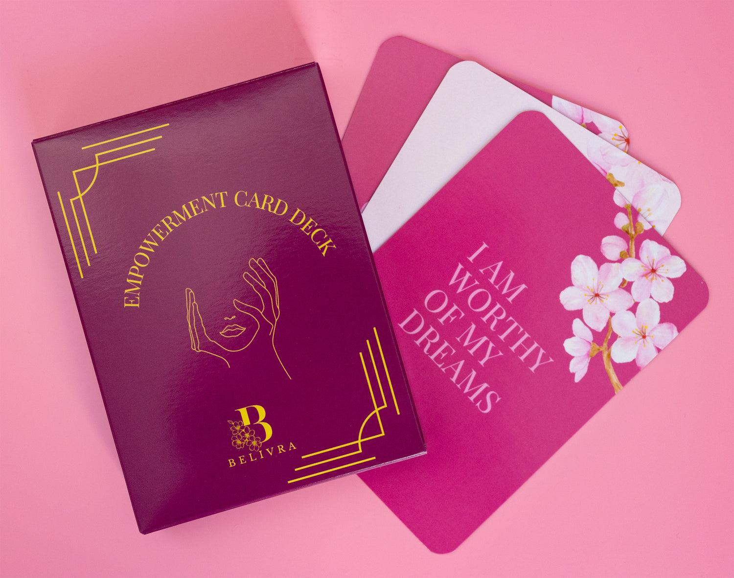 Belivra Empowerment Card Deck featuring bold pink and gold packaging with three affirmation cards partially displayed – including a floral design and the quote "I Am Worthy of My Dreams." A motivational tool for women focused on self-love, manifestation, and daily mindset shifts. Ideal for personal growth, journaling prompts, or thoughtful gifting.