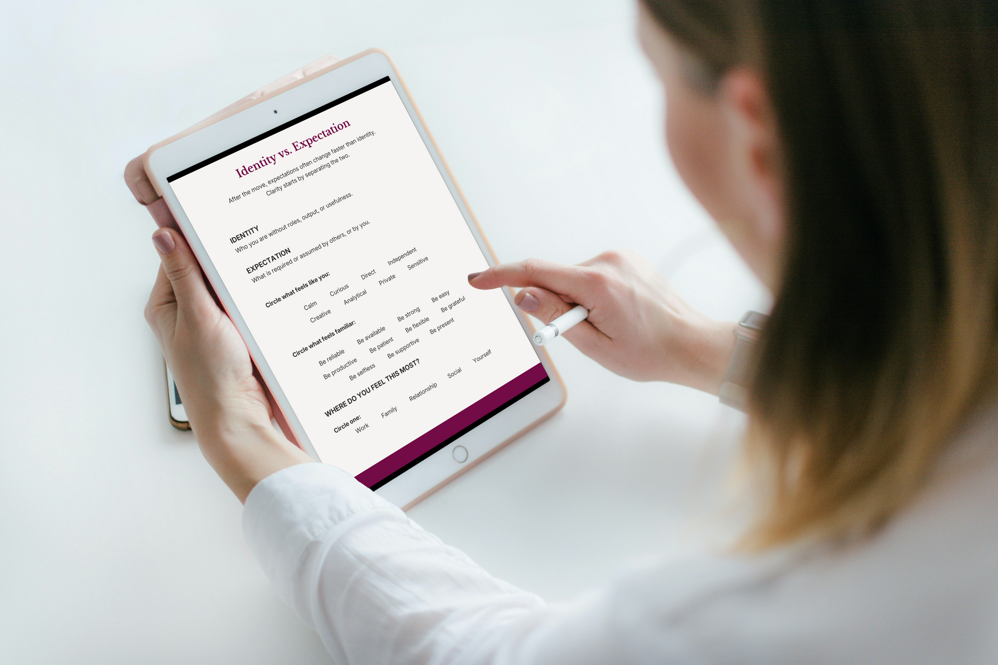 Woman using digital clarity workbook on tablet, identity vs expectation exercise for women after relocation