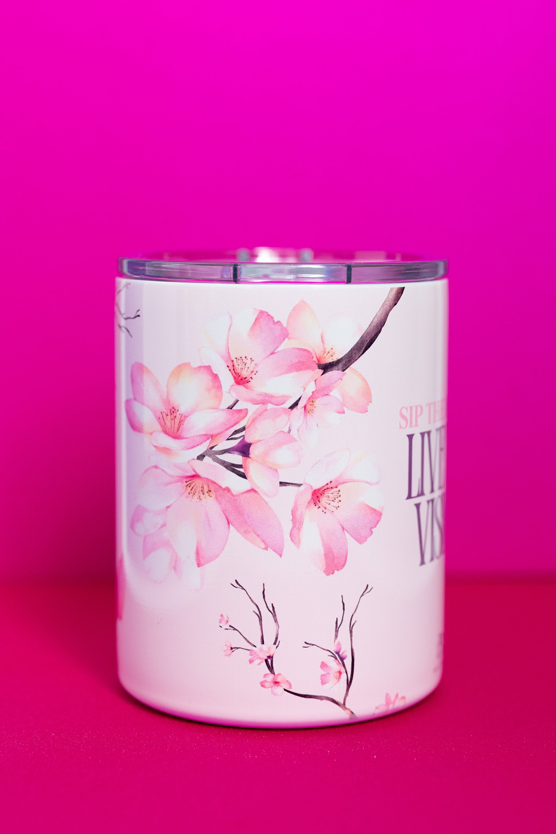 Close-up view of Belivra ceramic mug with delicate cherry blossom designs, showcasing the empowering phrase "Sip the Dream, Live the Vision." The mug features a spill-resistant lid, perfect for enjoying your favorite tea or coffee while embracing self-care and mindful moments. Ideal for sipping in style during morning routines or as an inspirational gift for women seeking daily motivation.
