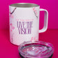 Belivra ceramic mug with the uplifting quote "Sip the Dream, Live the Vision" in purple and pink text, surrounded by delicate cherry blossom illustrations. The mug is displayed with a clear, spill-resistant lid, ideal for enjoying coffee, tea, or your favorite beverages while embracing goals and vision. Perfect for mindful sipping, desk decor, and inspiring morning rituals.