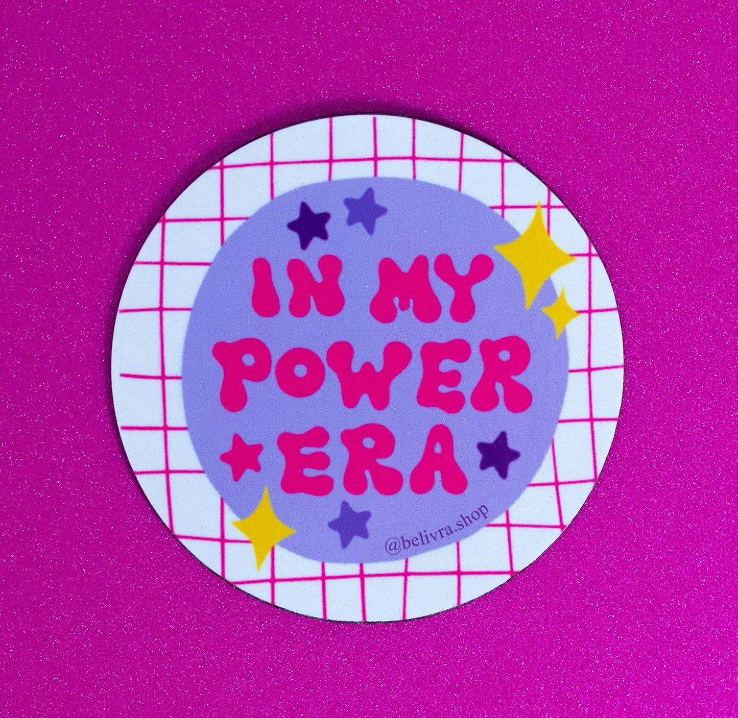 Belivra round motivational magnet with bold quote "In My Power Era" in playful pink and red text on a lavender background – surrounded by colorful stars and a hot pink grid pattern. Displayed on a glittery pink surface, this fun, empowering magnet is perfect for confident women, desk decor, or daily reminders of self-worth and ambition.