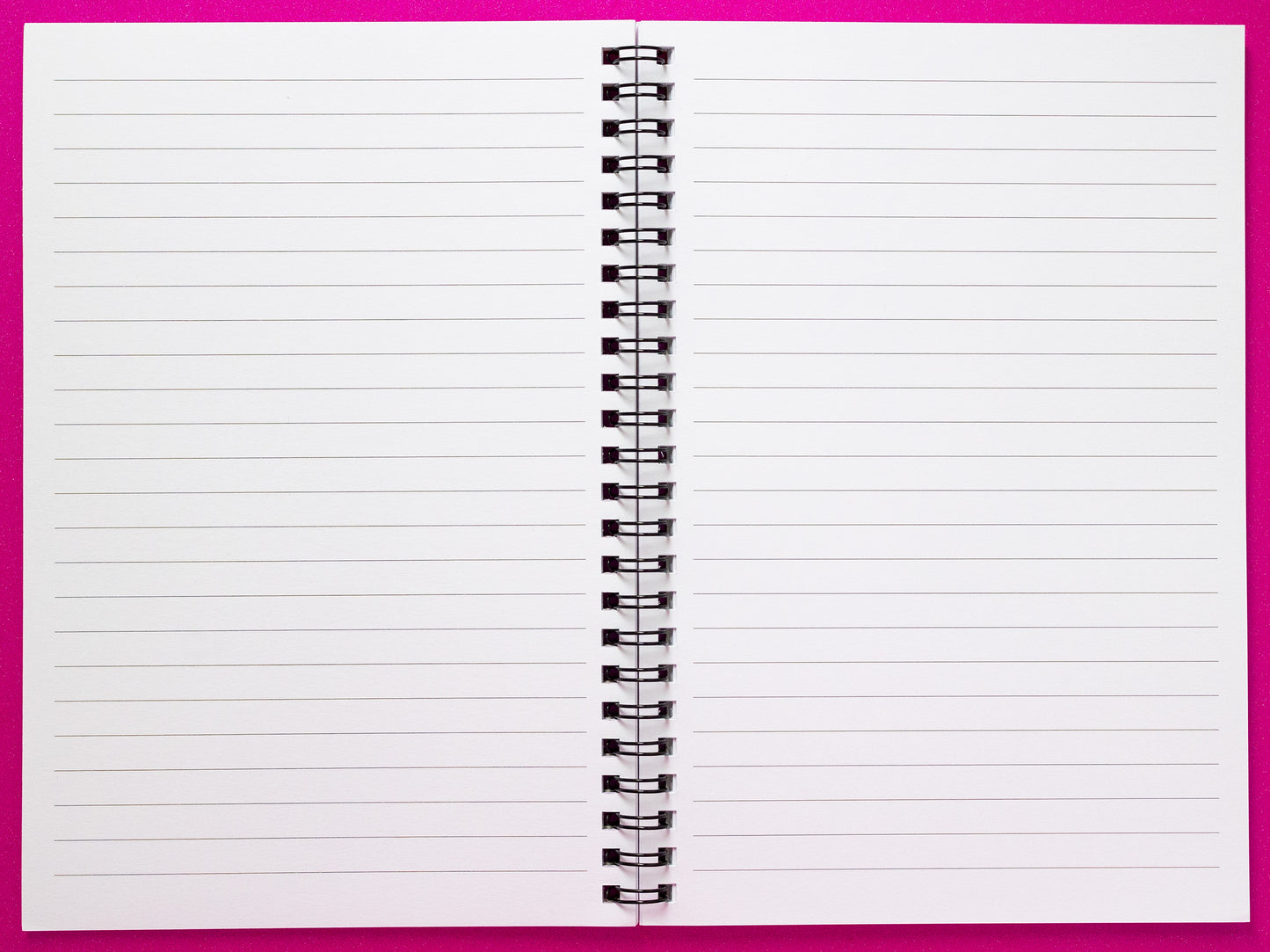 The interior of a spiral-bound notebook with blank lined pages, ideal for journaling, note-taking, goal setting, or creative writing. The smooth white pages feature evenly spaced lines for structured writing, providing a perfect canvas for personal growth, inspiration, and organization.