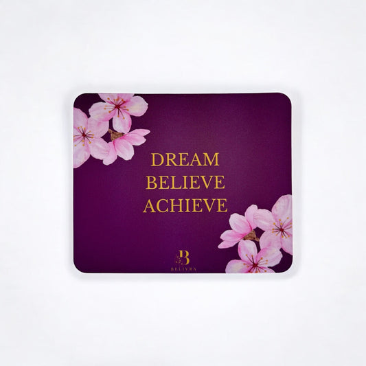 Belivra cherry blossom mouse pad with gold quote "Dream Believe Achieve" on a deep magenta background – inspirational desk accessory for women, perfect for home office decor, productivity boost, and empowering workspace vibes. Features elegant floral design for a feminine touch.