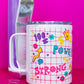 Side view of Belivra insulated tumbler mug with clear lid, featuring colorful doodles and bold words like "Power" and "Strong" on a pink grid background – decorated with symbols like a crown, flexing arm, dollar signs, and flowers. Styled on a vibrant pink surface with a retro phone and paperclips, perfect for on-the-go drinks, desk motivation, and empowering daily rituals.