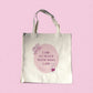 Cream tote bag with the quote “I Am at Peace with Who I Am” in soft plum and blush tones, featuring floral and feminine line art symbolizing mindfulness and self-love.