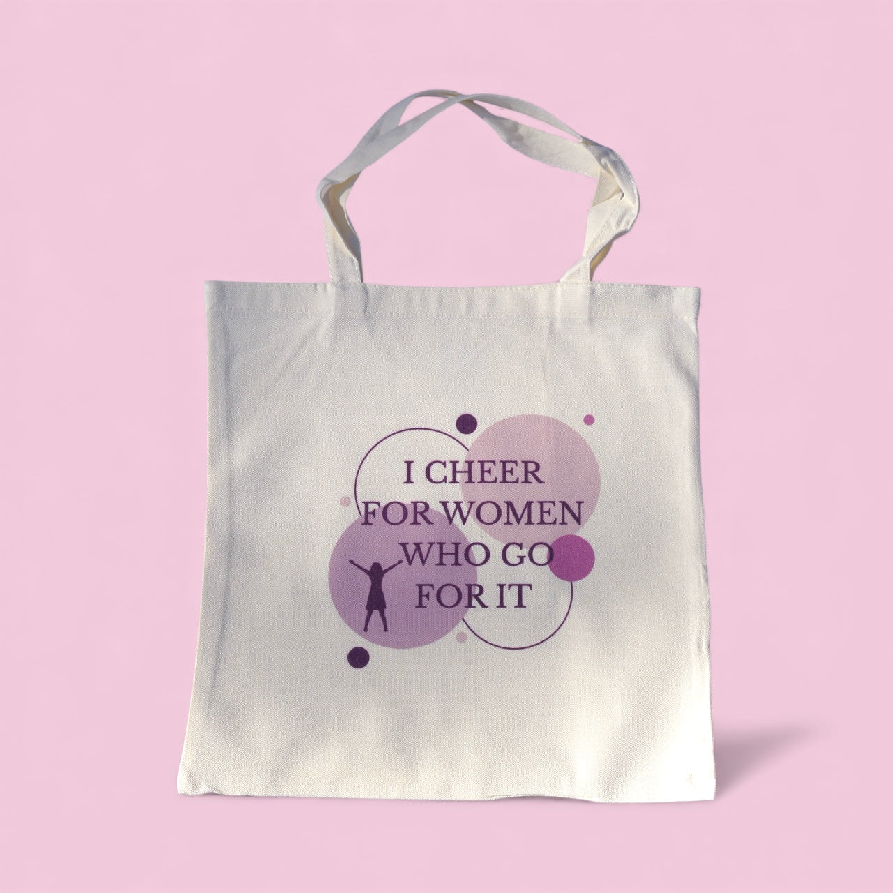 Cream polyester tote bag with “I Cheer for Women Who Go For It” quote in purple, symbolizing sisterhood and empowerment by Belivra.
