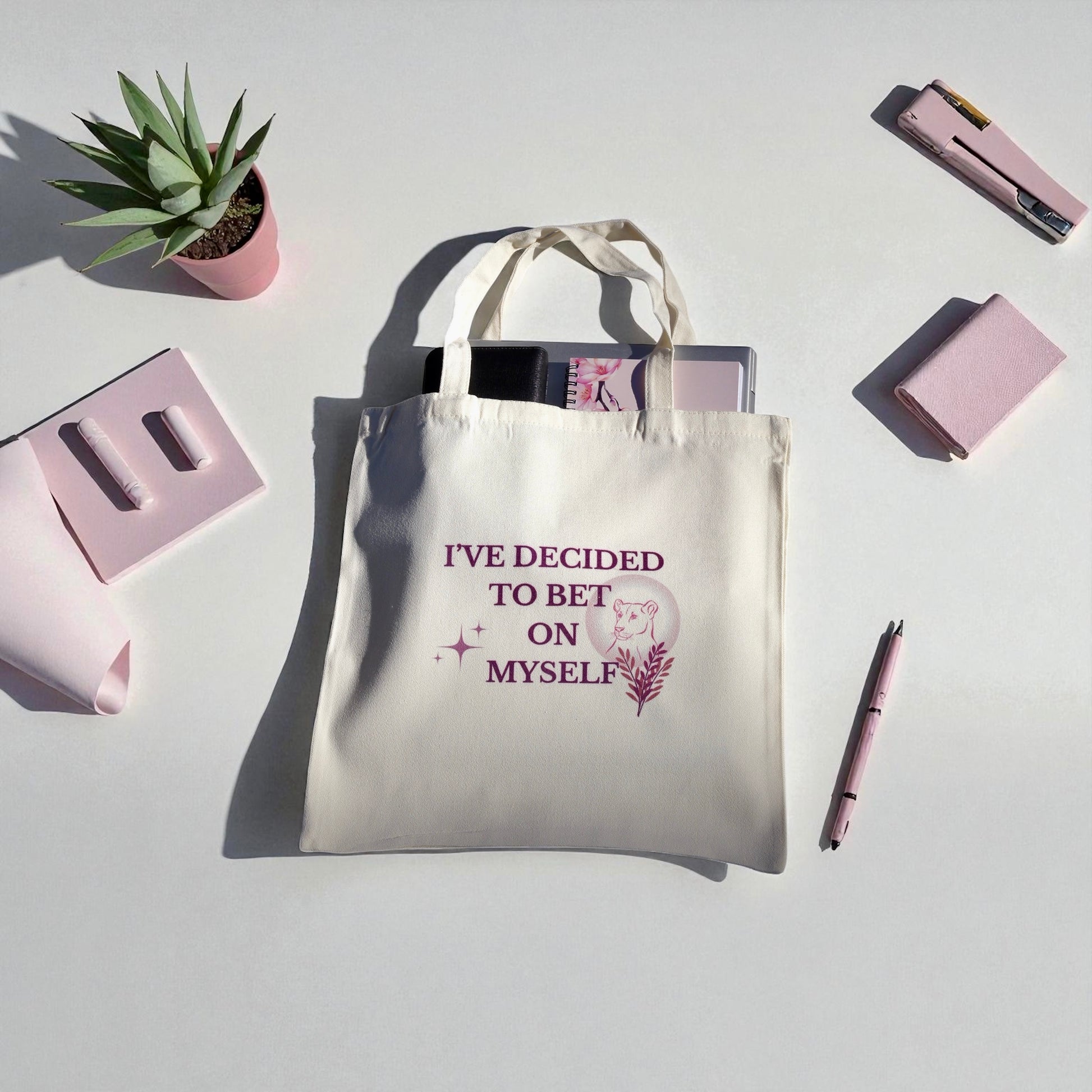Cream tote bag with the quote “I’ve Decided to Bet on Myself” in plum lettering, featuring a minimalist lioness and botanical design representing courage and self-belief.