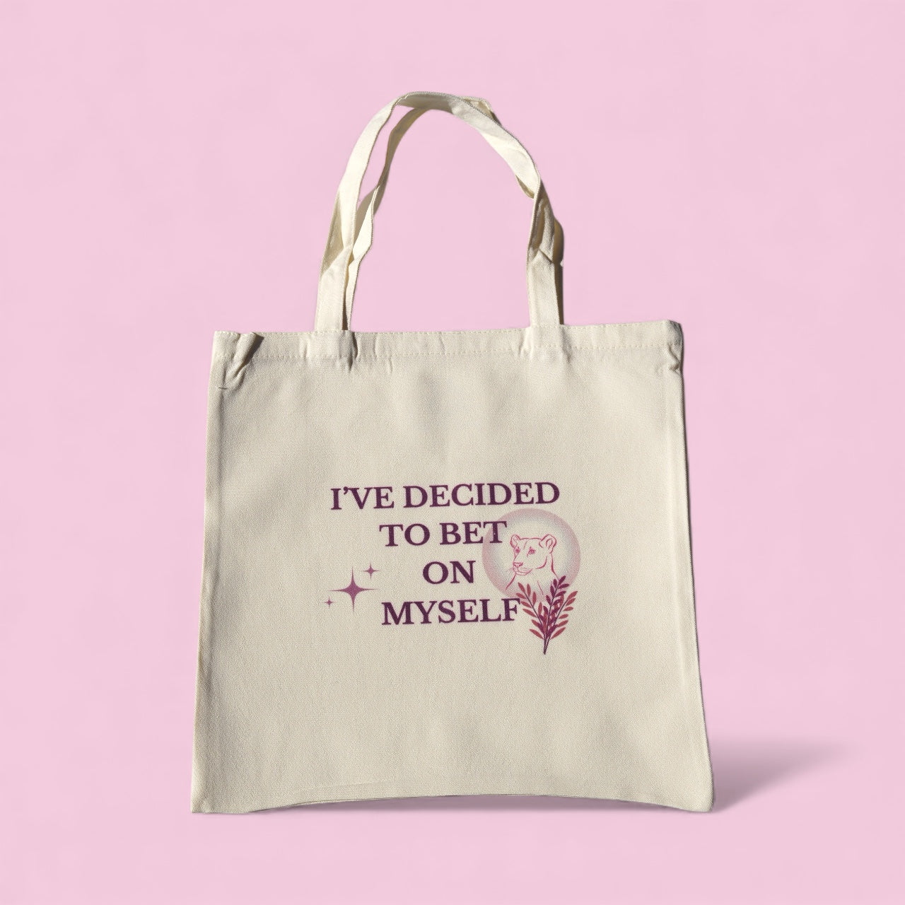 Cream tote bag with the quote “I’ve Decided to Bet on Myself” in plum lettering, featuring a minimalist lioness and botanical design representing courage and self-belief.