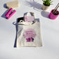 Cream polyester tote bag with “Strong Women Don’t Compete, We Connect” quote in purple tones, symbolizing women’s empowerment and unity by Belivra.