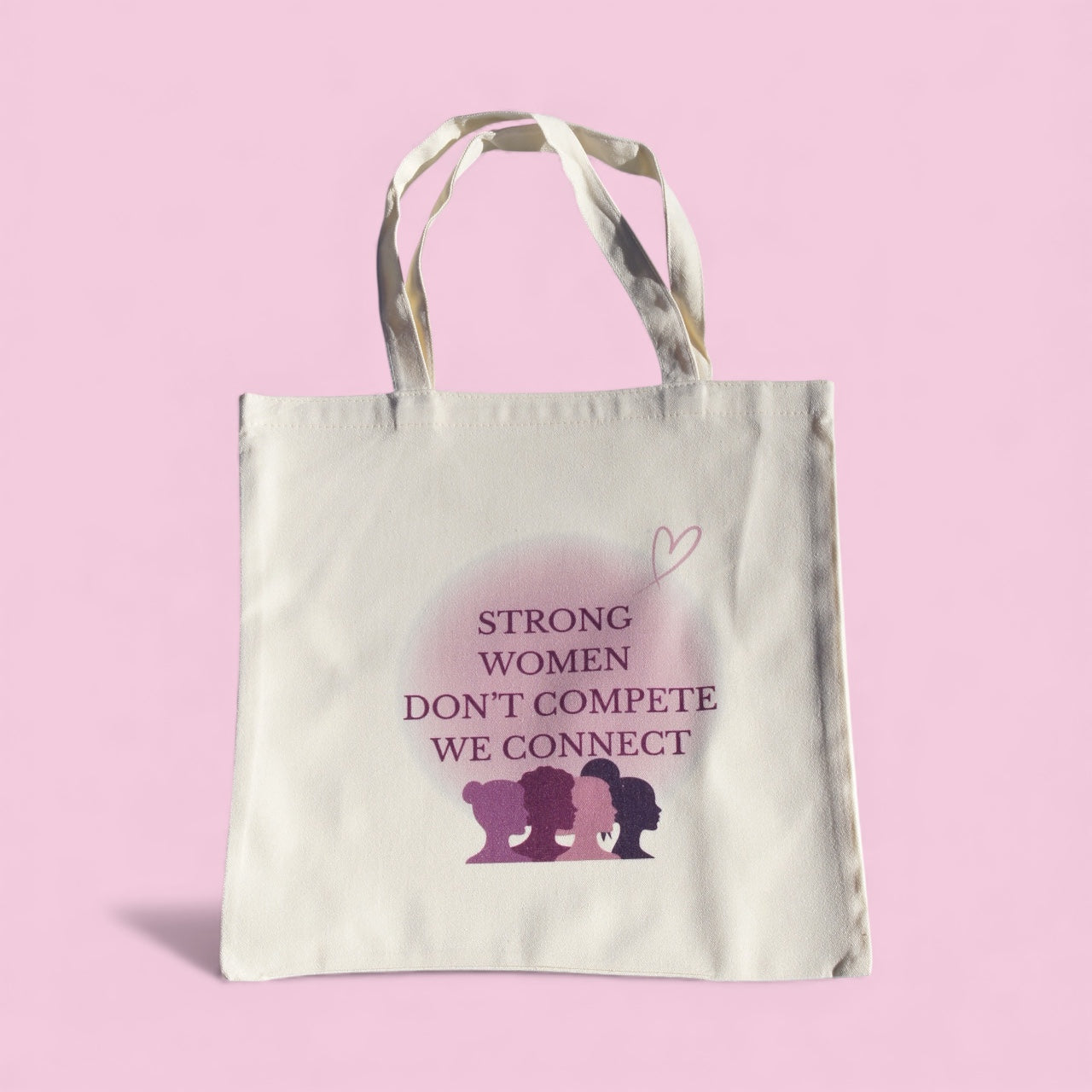 Cream polyester tote bag with “Strong Women Don’t Compete, We Connect” quote in purple tones, symbolizing women’s empowerment and unity by Belivra.