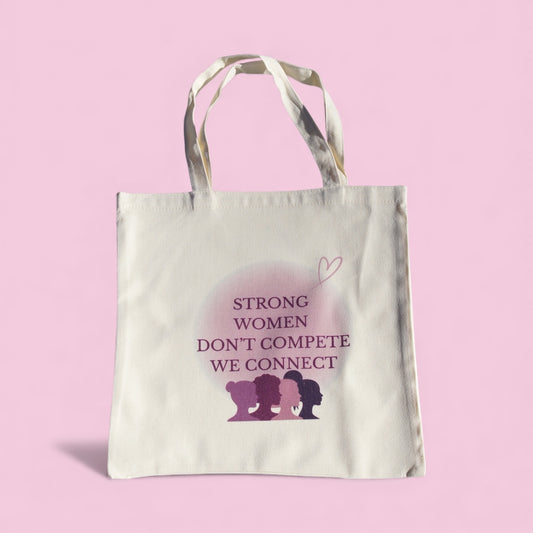 Cream polyester tote bag with “Strong Women Don’t Compete, We Connect” quote in purple tones, symbolizing women’s empowerment and unity by Belivra.