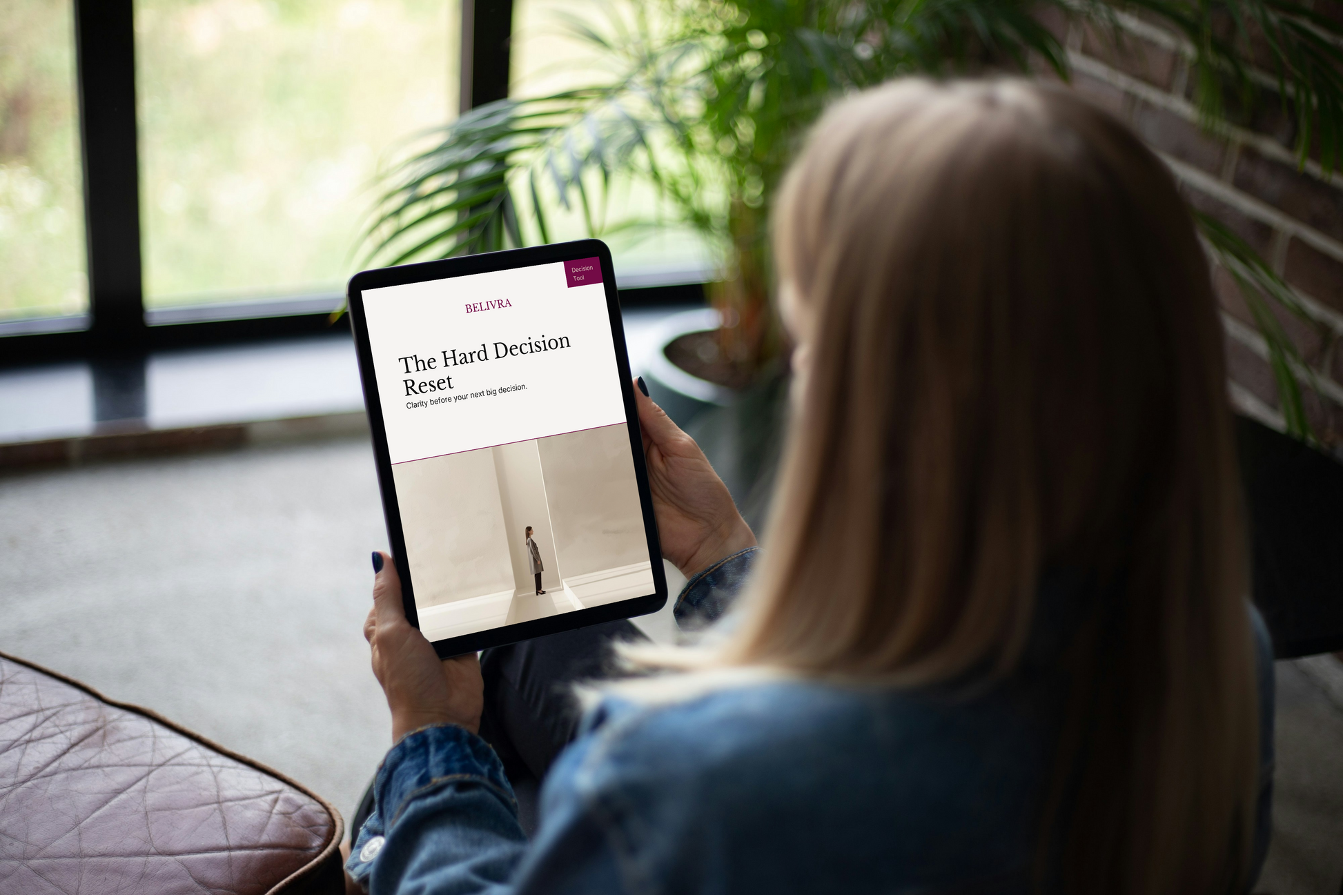 Woman using The Hard Decision Reset decision clarity workbook on a tablet to think through a difficult life decision.